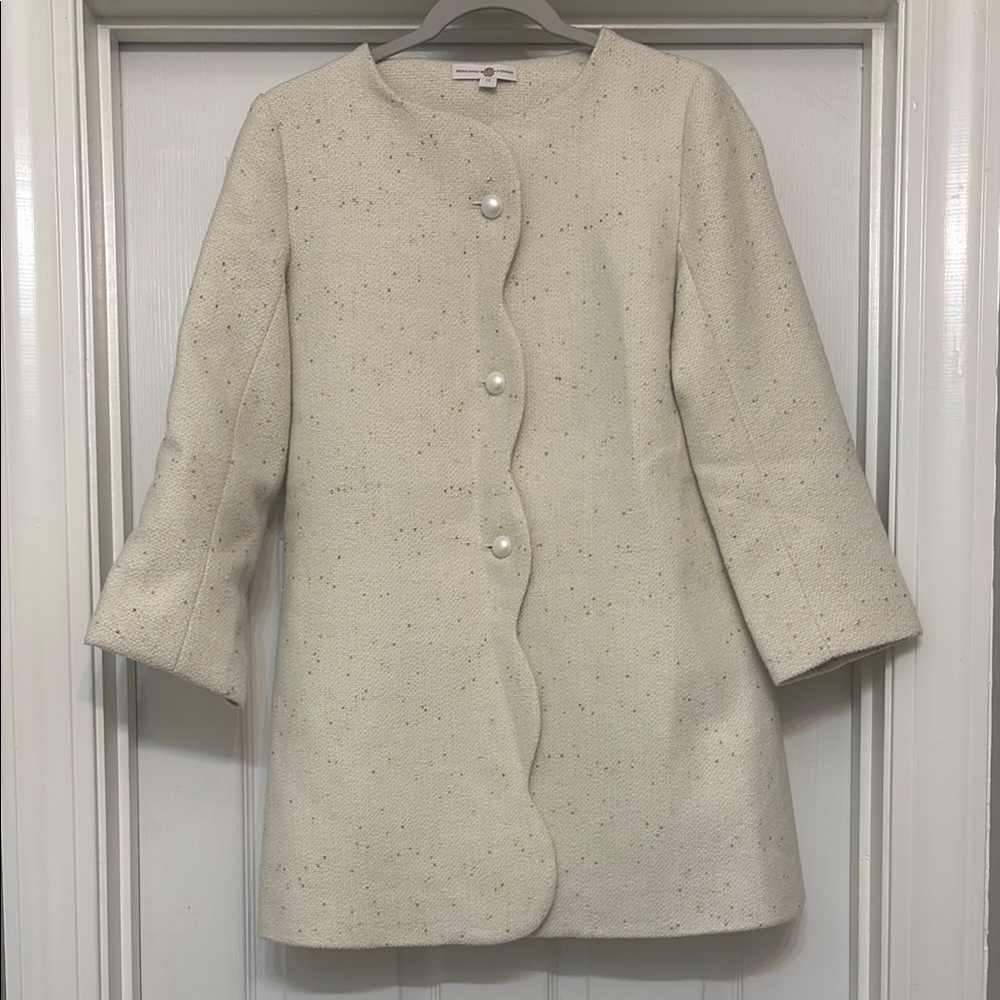 Girls cream coat. Brown Bowen & Co.